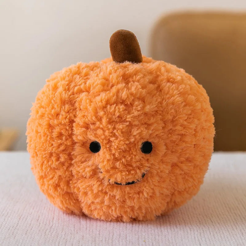 Kawaii plush pumpkin toy with a smiling face on a light surface