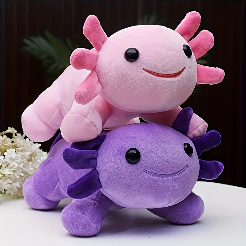 Two kawaii plush axolotls, one pink and one purple, on a dark background.
