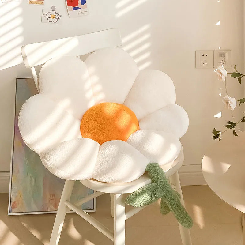 Flower-shaped Kawaii cushion on a chair in a room with a plant and wall art.