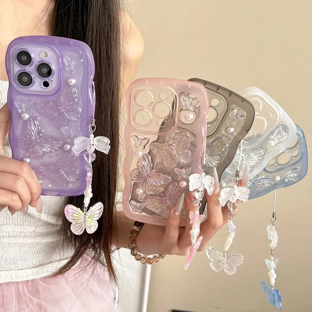 Three phone cases with kawaii butterfly designs held by a person against a neutral background