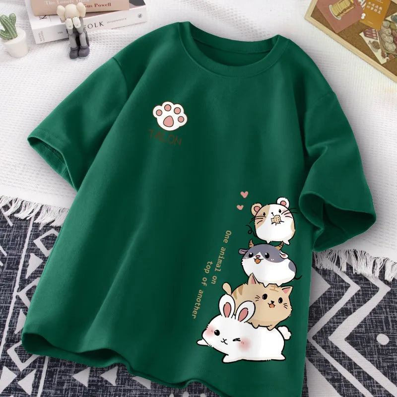 Green t-shirt with kawaii cartoon animal designs on a white surface