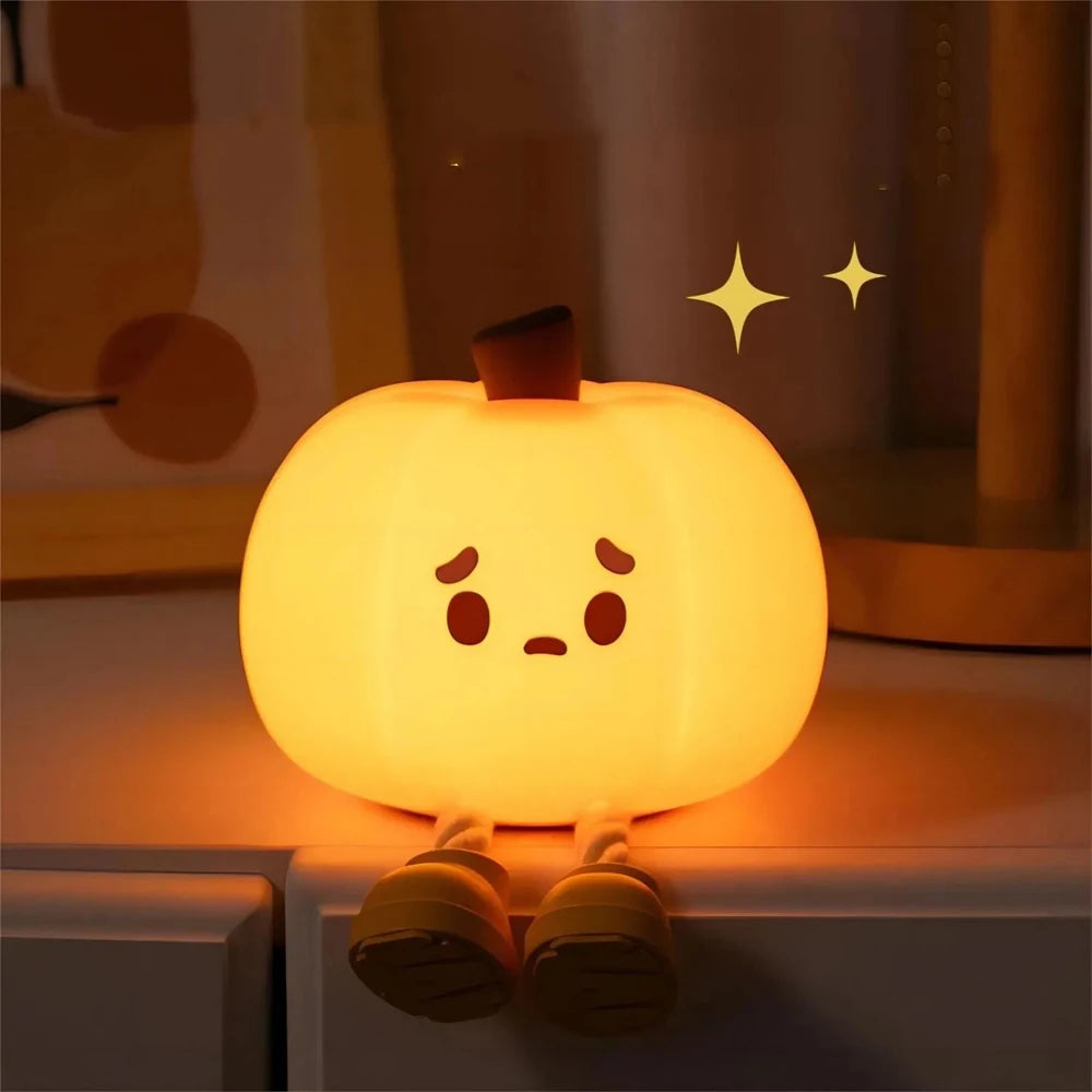Cute kawaii pumpkin-shaped night light with a face on a shelf.