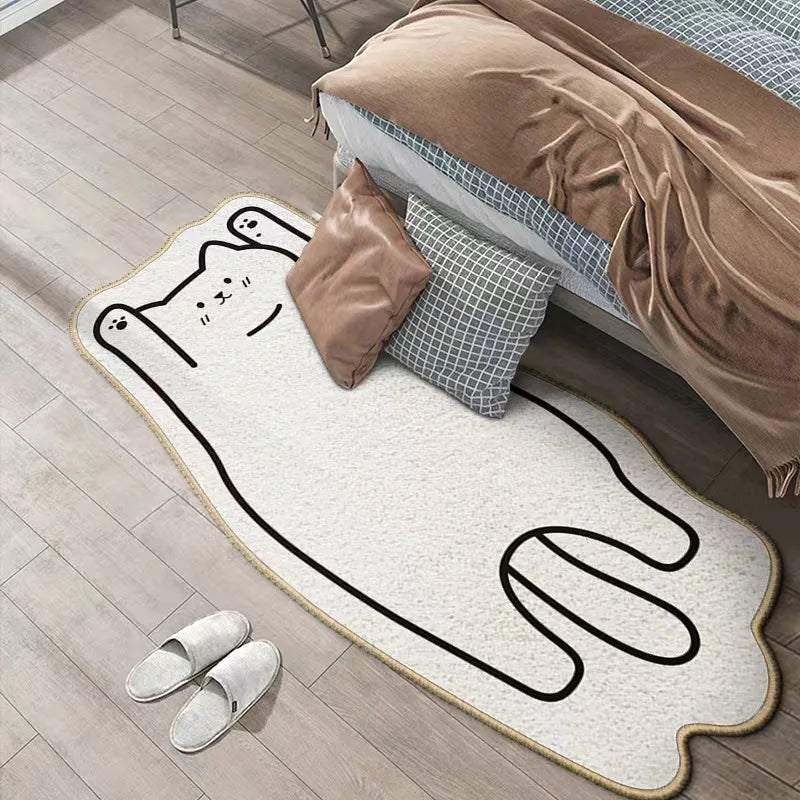 Kawaii cat-shaped rug on a wooden floor with pillows and a blanket in the background