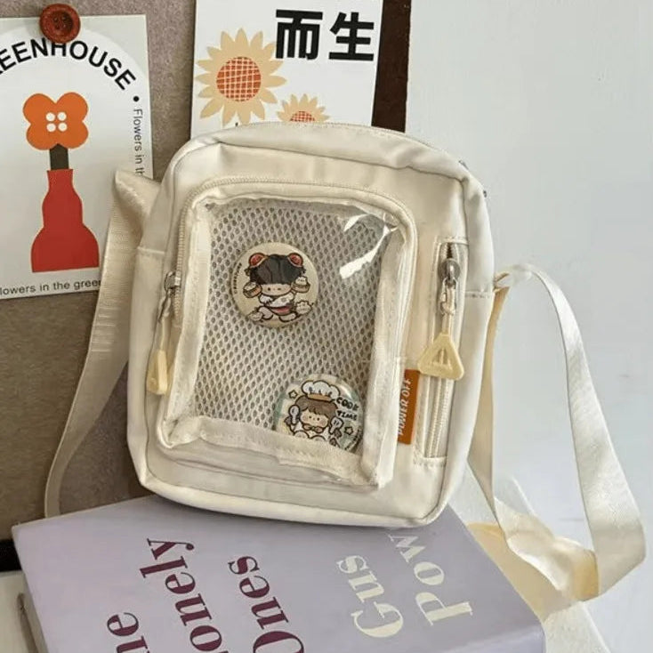 Clear bag with Kawaii cartoon character design on a surface with books and cards.