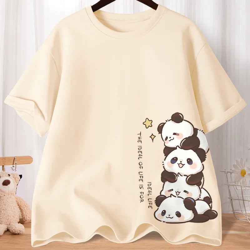 Beige t-shirt with kawaii panda design on a wooden surface