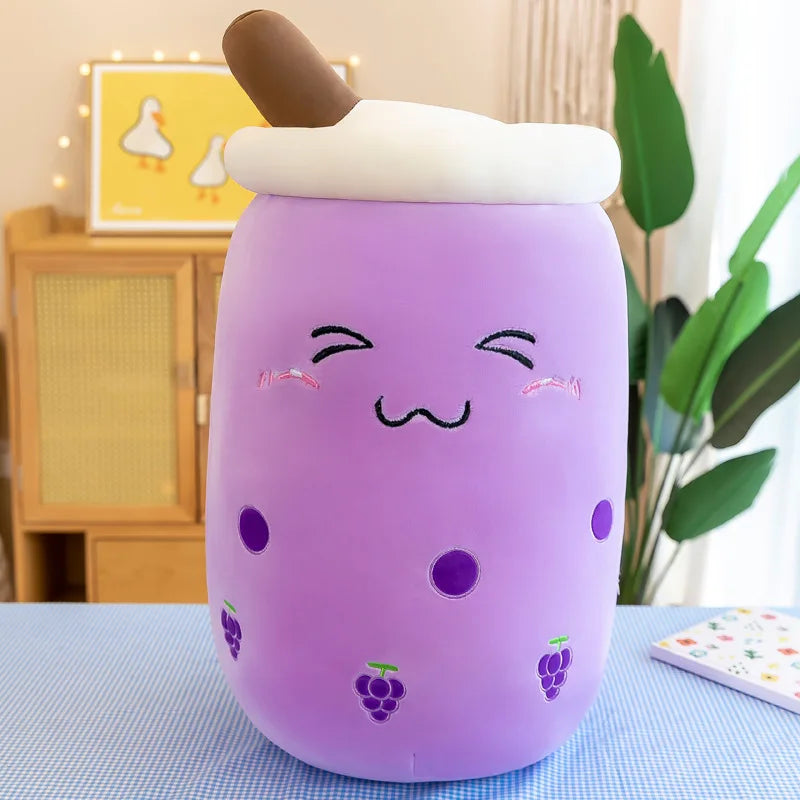 Purple kawaii plush toy with a face and grape designs on a table