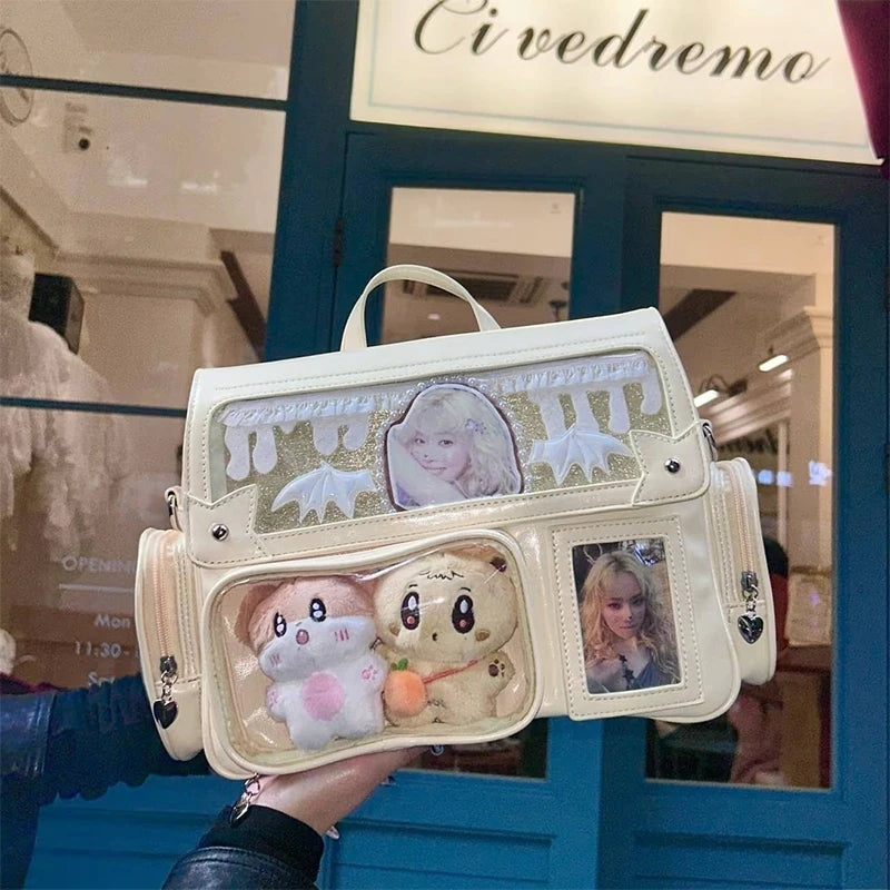 White handbag with Kawaii cartoon characters and photos held in front of a store entrance.