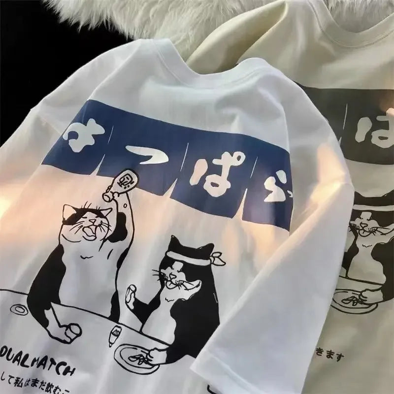 White sweatshirt with kawaii black and blue cat graphic design on a white background
