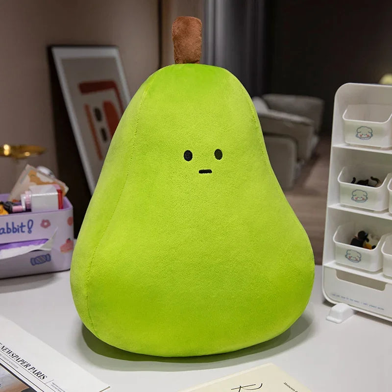 Plush kawaii toy shaped like a green pear with a face on a desk