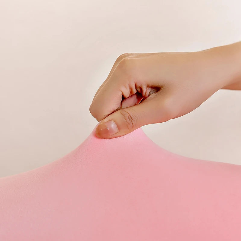 Hand holding a kawaii pink fabric against a light background