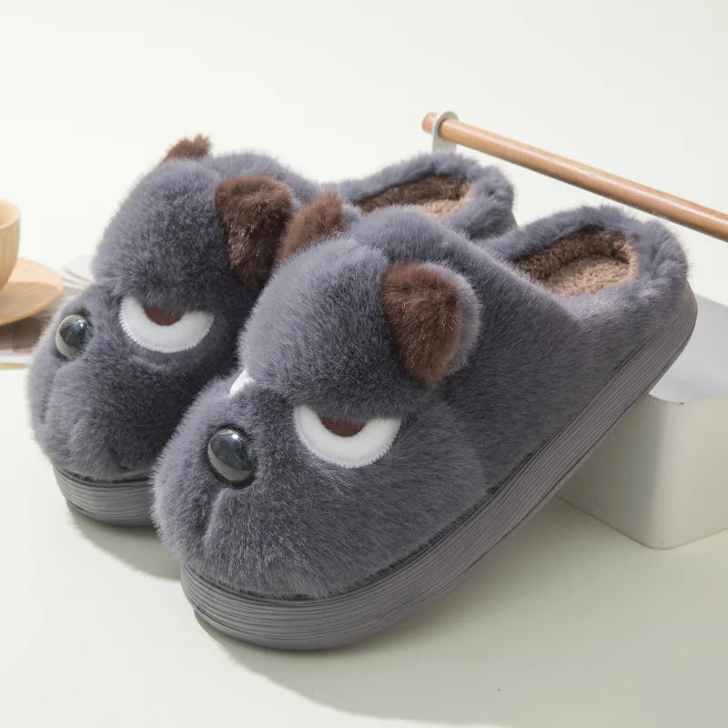 Gray slippers with kawaii cartoon face design on a white background