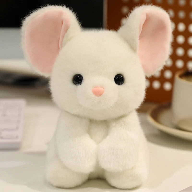 White plush kawaii toy with pink ears on a blurred background