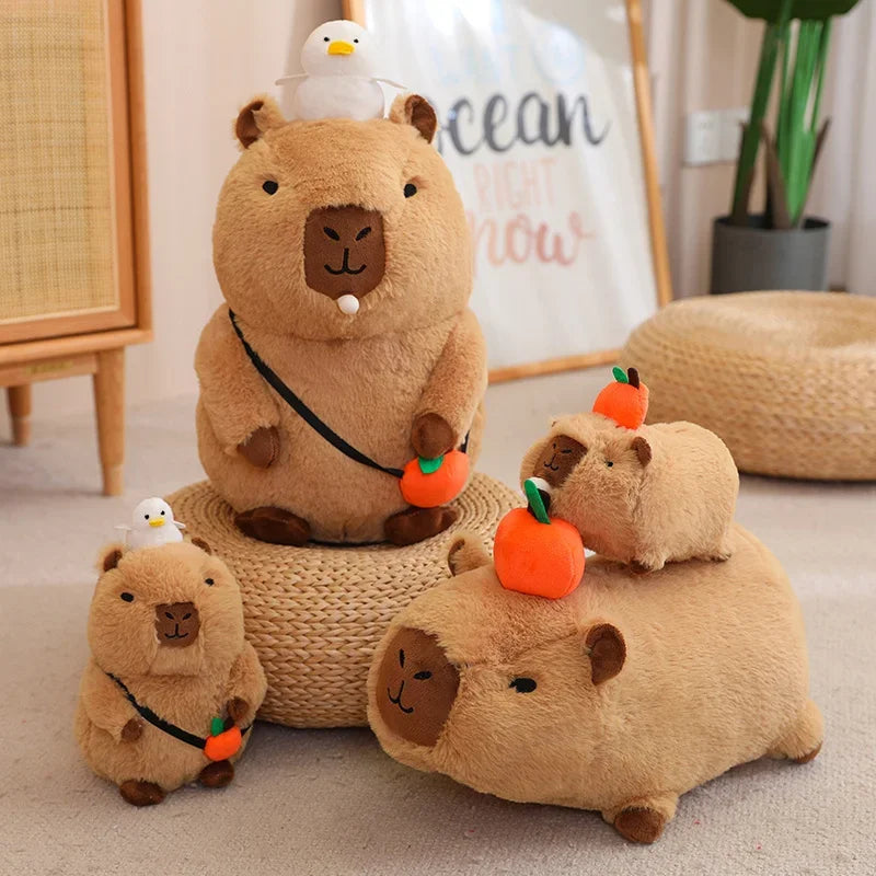a group of kawaii capybara plush toys with ducks and oranges