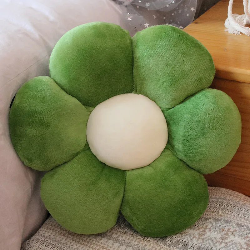 Green flower-shaped Kawaii cushion with a white center on a wooden surface.