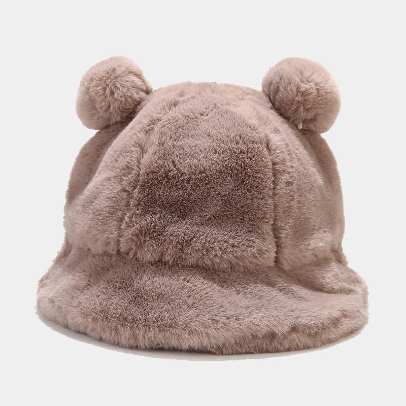 Fluffy beige Kawaii hat with two pom-poms on a light gray background