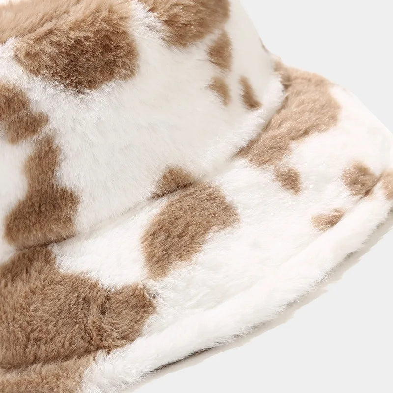 Close-up of a brown and white fur Kawaii hats on a light gray background