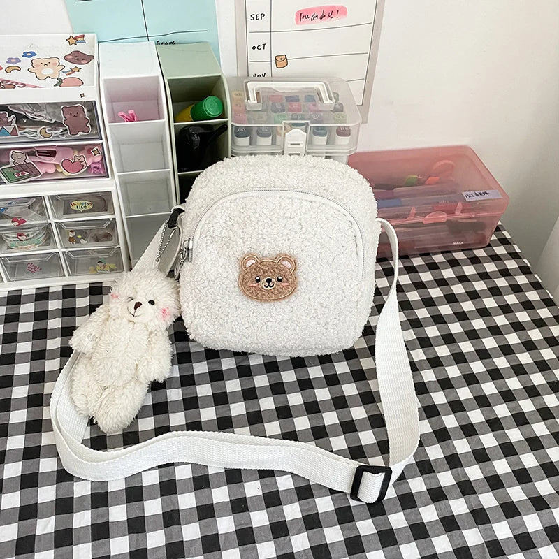 White fluffy bag with a Kawaii teddy bear emblem on a checkered tablecloth