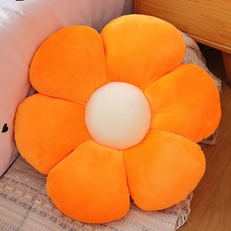 Orange flower-shaped Kawaii cushion on a wooden floor