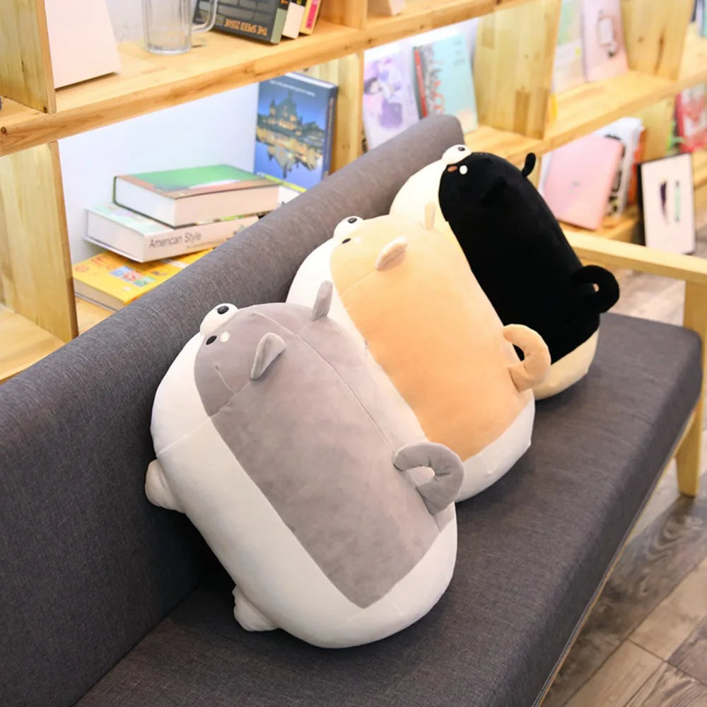 Three kawaii cartoon-style slippers in gray, yellow, and black on a gray surface with a bookshelf in the background.