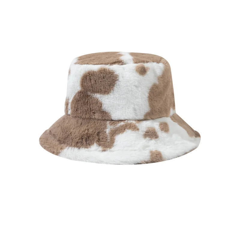 Kawaii bucket hat with brown and white cow print pattern on a white background