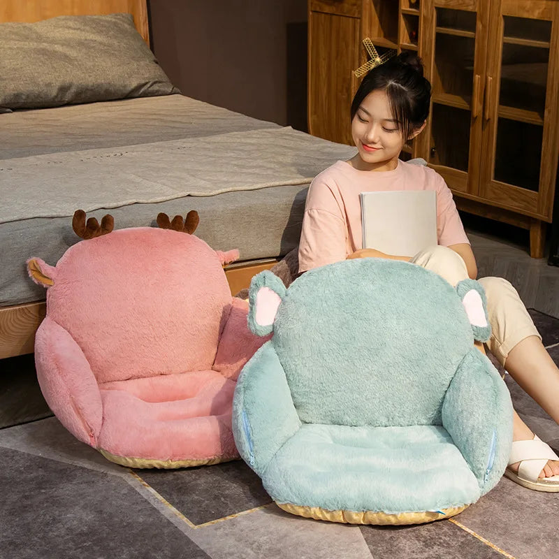 Child sitting on a blue kawaii plush chair with animal ears in a room with a bed and wooden furniture.