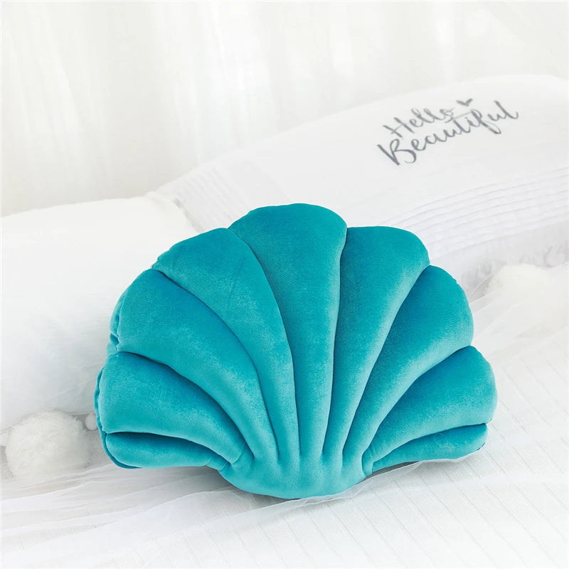Turquoise shell-shaped kawaii pillow on a white background with 'Hello Beautiful' text.