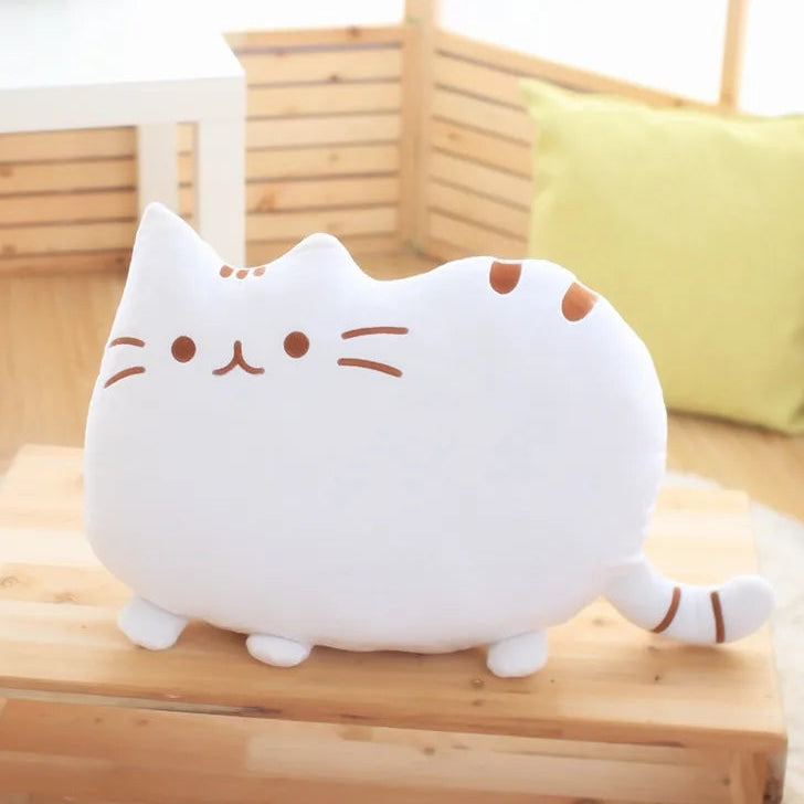 Cute cat-shaped plush kawaii toy on a wooden surface with a blurred background