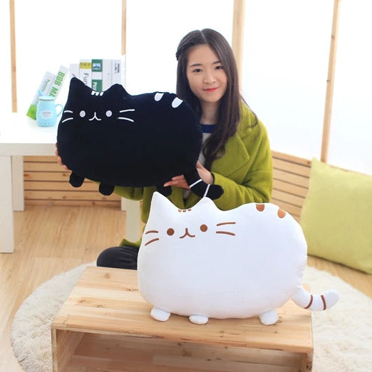 Woman holding a black cat-shaped plush kawaii toy in a room with wooden flooring and furniture.