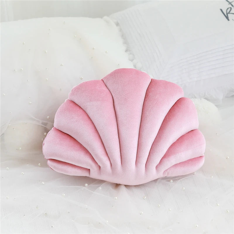 Pink shell-shaped kawaii pillow on a white background