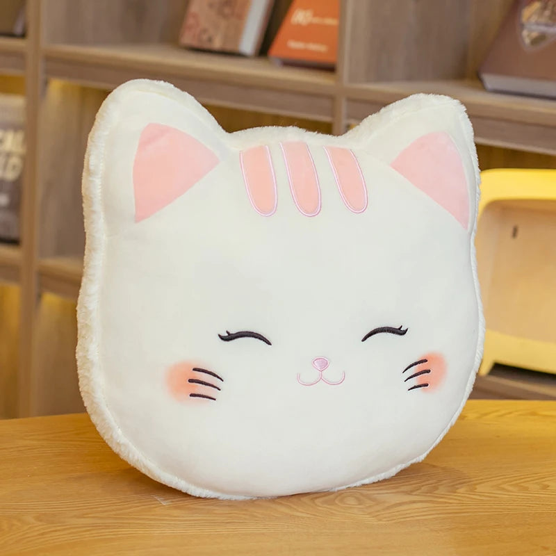 Cat-shaped kawaii cushion with pink accents on a wooden surface