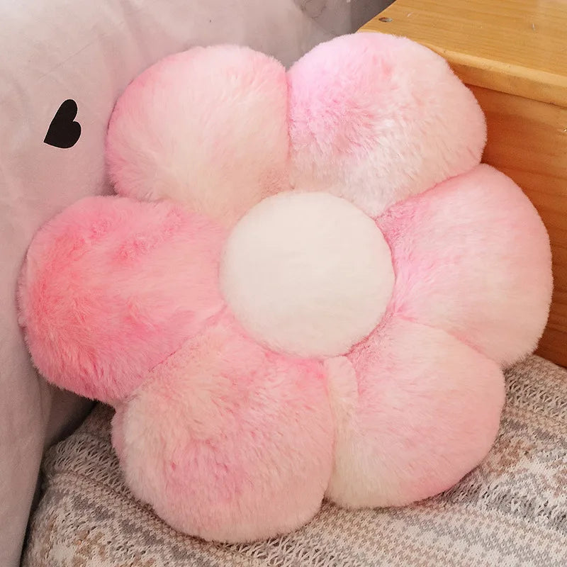 Fluffy pink flower-shaped Kawaii cushion on a textured surface