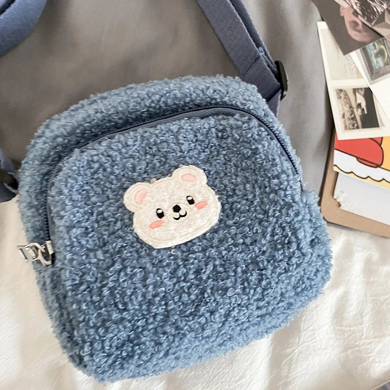 Blue fluffy bag with a Kawaii bear patch on a light background
