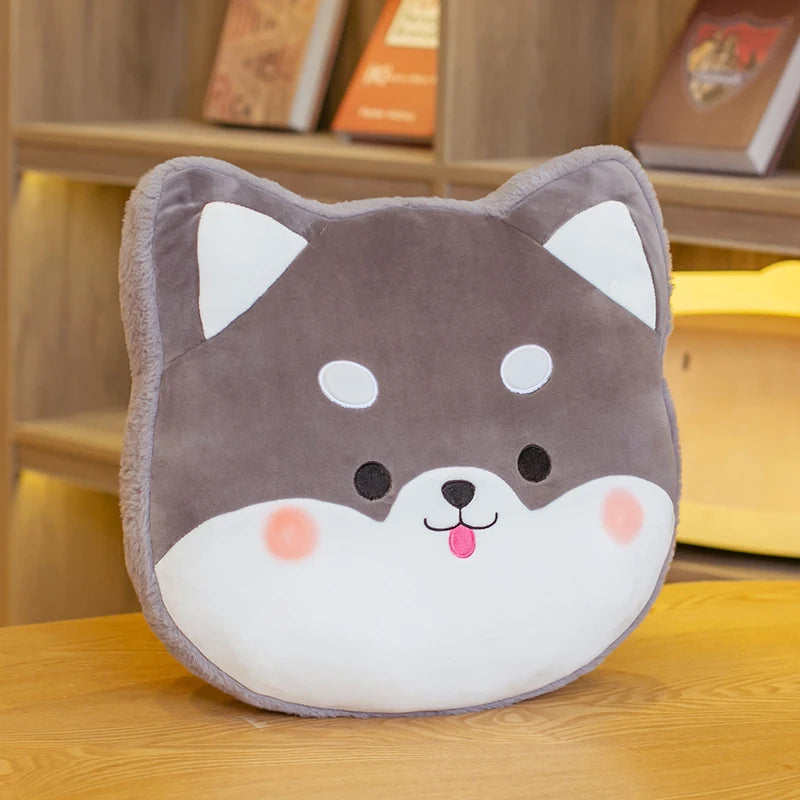 Plush kawaii pillow shaped like a dog's face on a wooden surface with books in the background