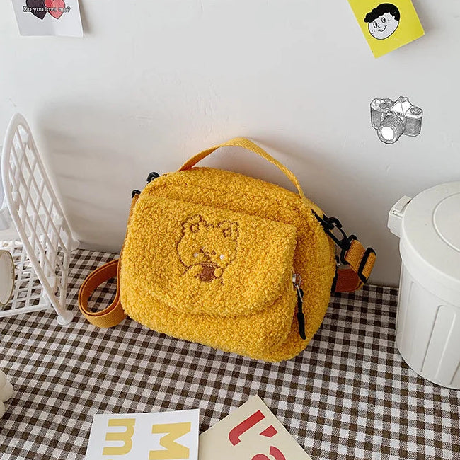 Yellow textured bag with a Kawaii bear design on a checkered floor