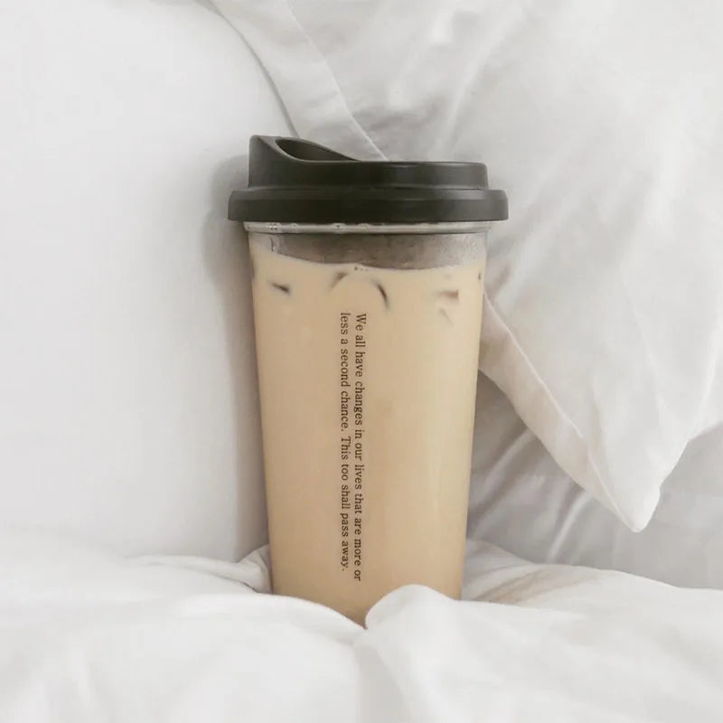 Iced coffee Kawaii cup with a black lid on white fabric