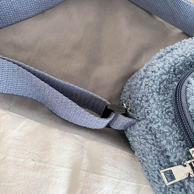 Close-up of a blue textured Kawaii-style bag strap and corner on a light brown surface.