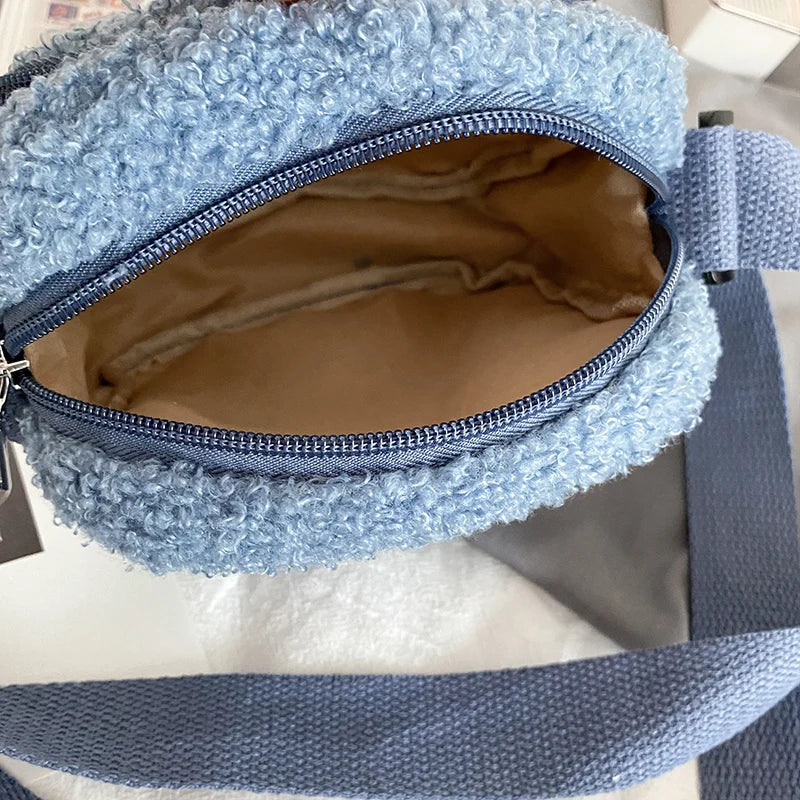 Blue textured Kawaii-style bag with a brown interior on a white surface