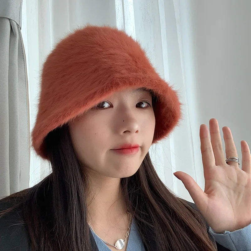 Person wearing a red fur Kawaii hat with a neutral background