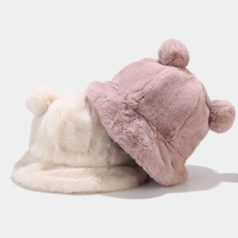 Two fluffy Kawaii hats, one white and one pink, on a light gray background