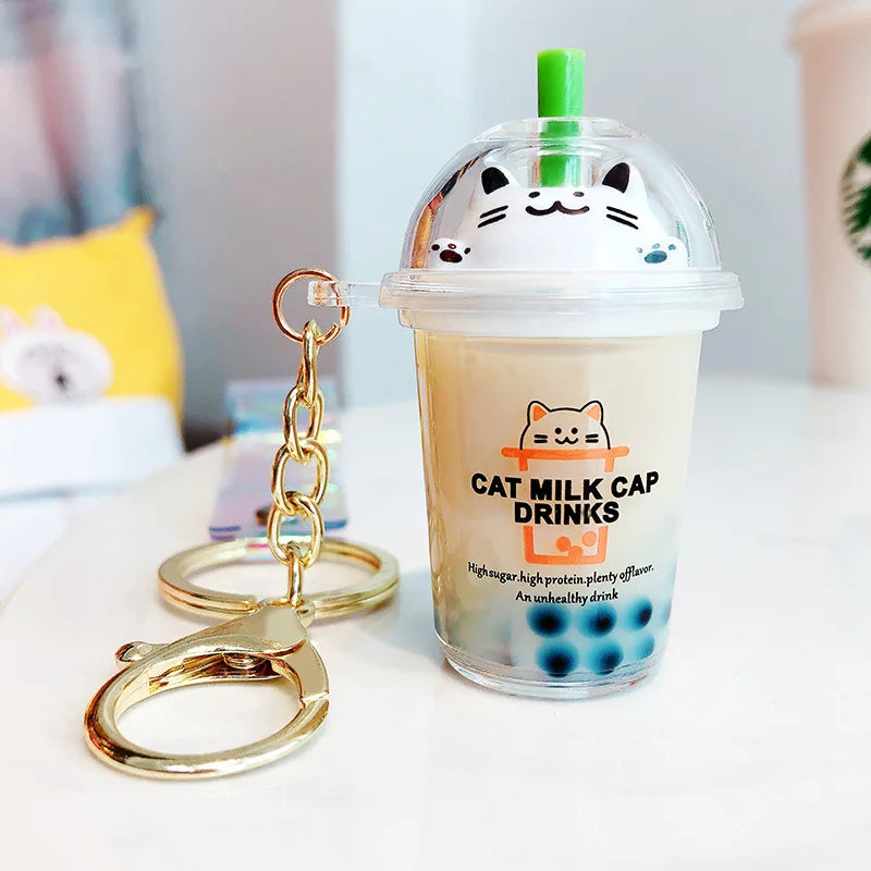 Cat milk cap drink kawaii keychain with a transparent cup design on a white surface.