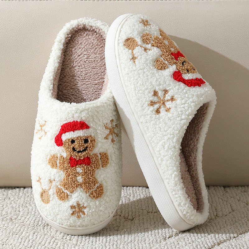 Pair of white slippers with kawaii gingerbread man design on a neutral background