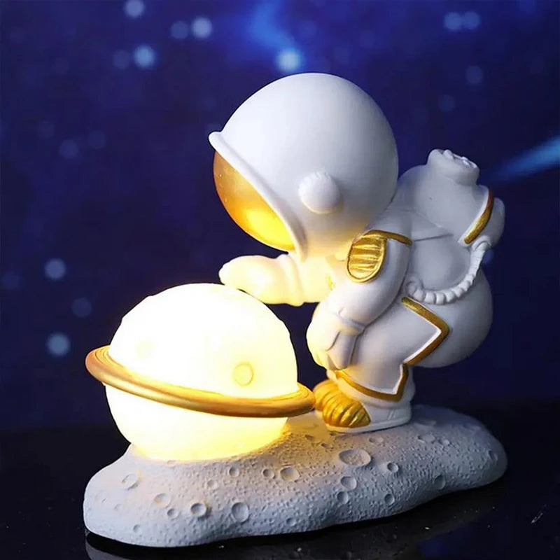 Decorative kawaii figurine of an astronaut with a glowing sphere on a dark background