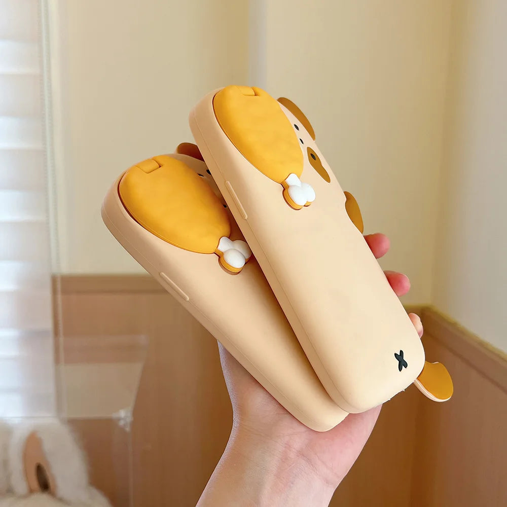 Hand holding a beige and yellow kawaii cartoon-style phone case with a soft background