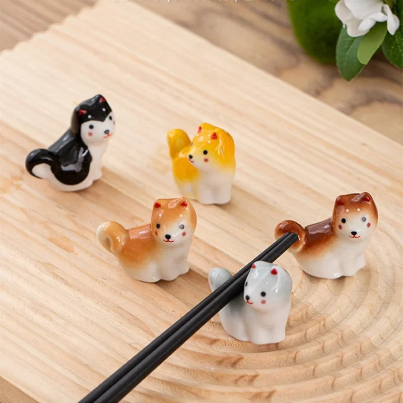 Set of small kawaii animal figurines on a wooden surface with chopsticks.