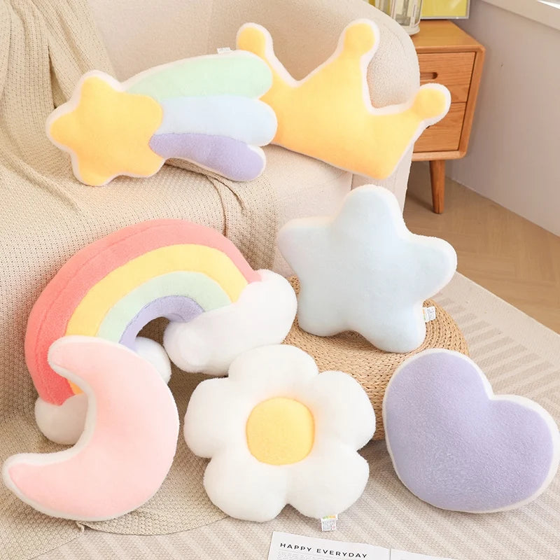 Set of colorful kawaii plush toys shaped like a rainbow, star, moon, and flower on a beige couch.