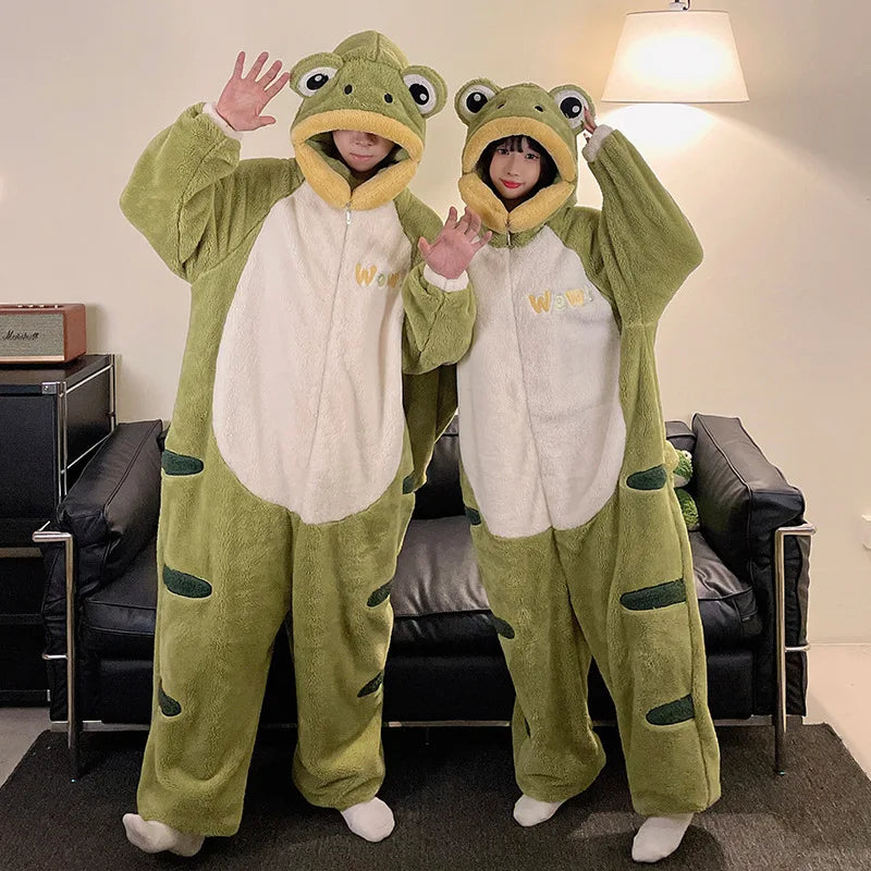 Two people wearing green kawaii frog onesies in a living room.