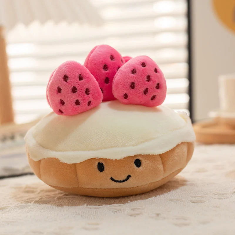 Plush kawaii toy shaped like a cake with strawberry decorations on a neutral background