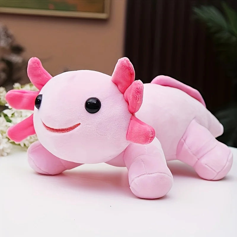 Pink axolotl kawaii plush toy on a light surface with a blurred background