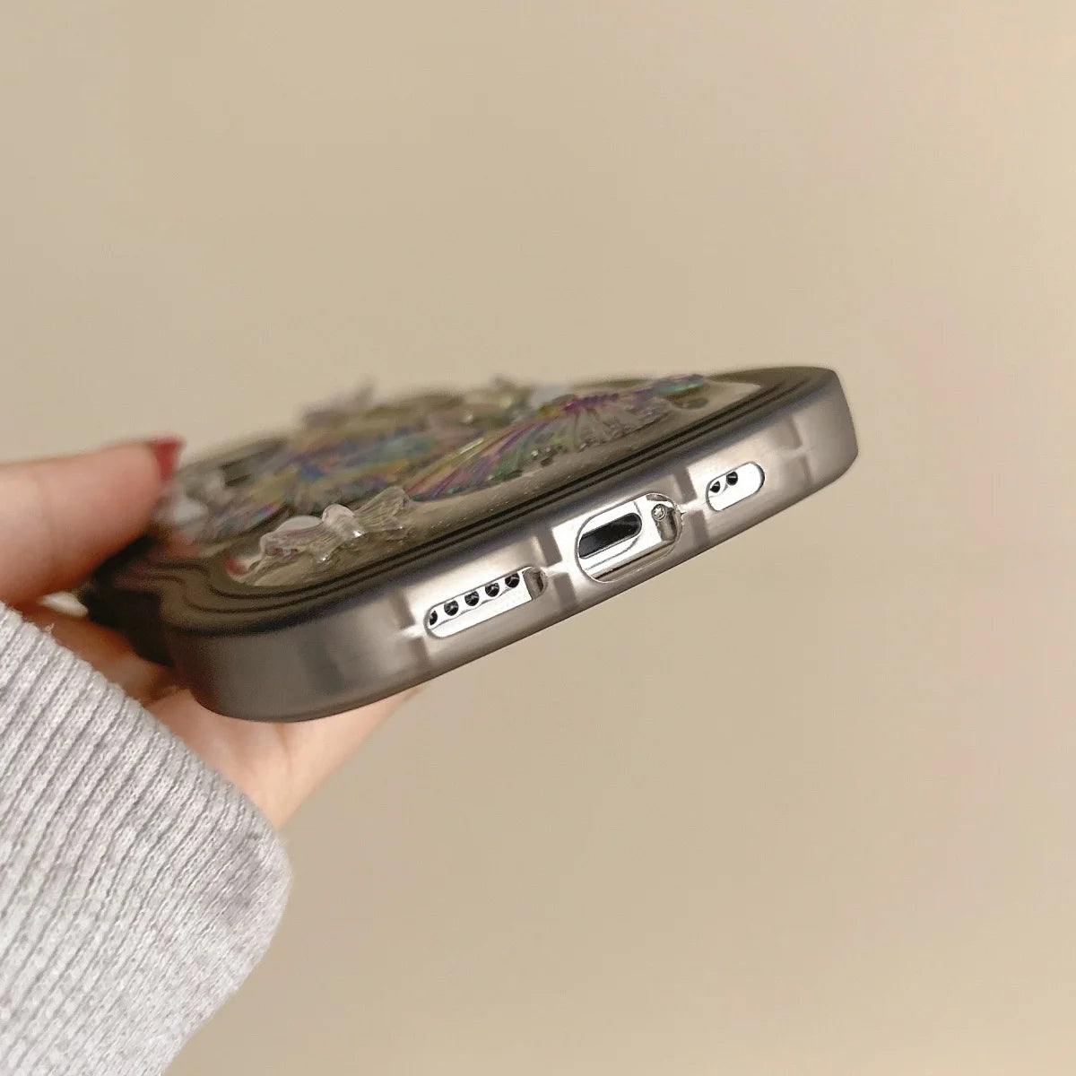 Phone case with kawaii floral design held by a hand against a beige background