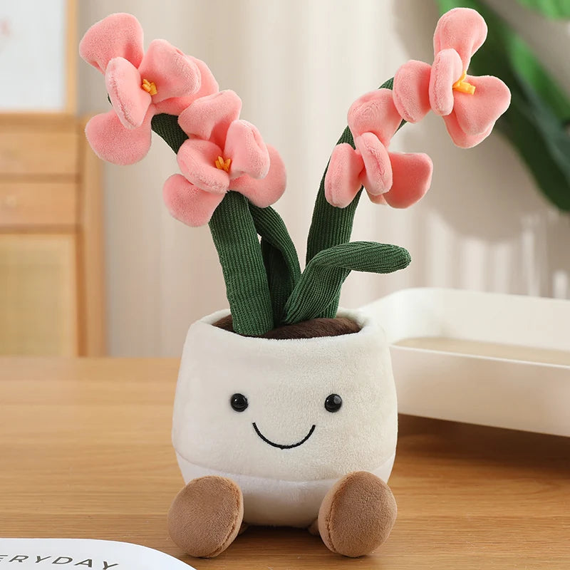 Plush kawaii toy plant with pink flowers and a smiling face on a wooden surface.